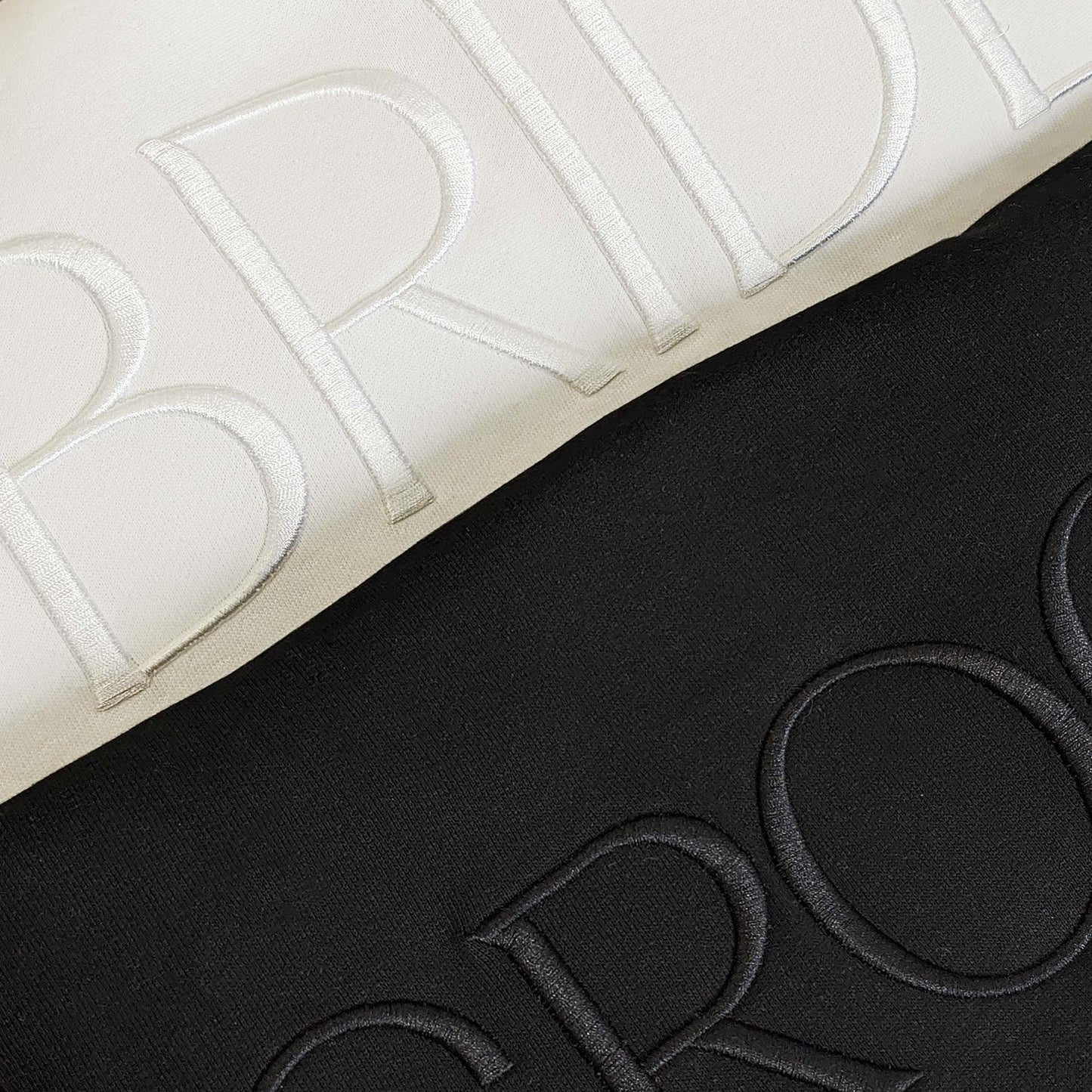 The set of two matching crewneck embroidered sweatshirts, white Bride sweatshirt and black Groom sweatshirt.