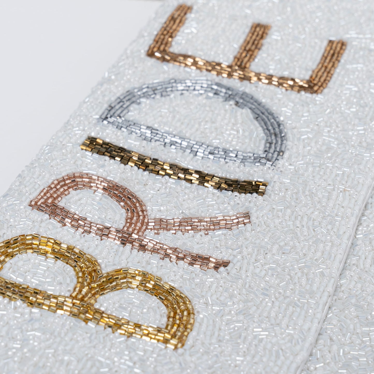 Beaded Bride Purse. Covered in shiny white seed beads, this purse has BRIDE outlined with complementing gold, rose gold, bronze, copper and metallic silver seed beads. Can be accessorized as a clutch or worn as a purse.