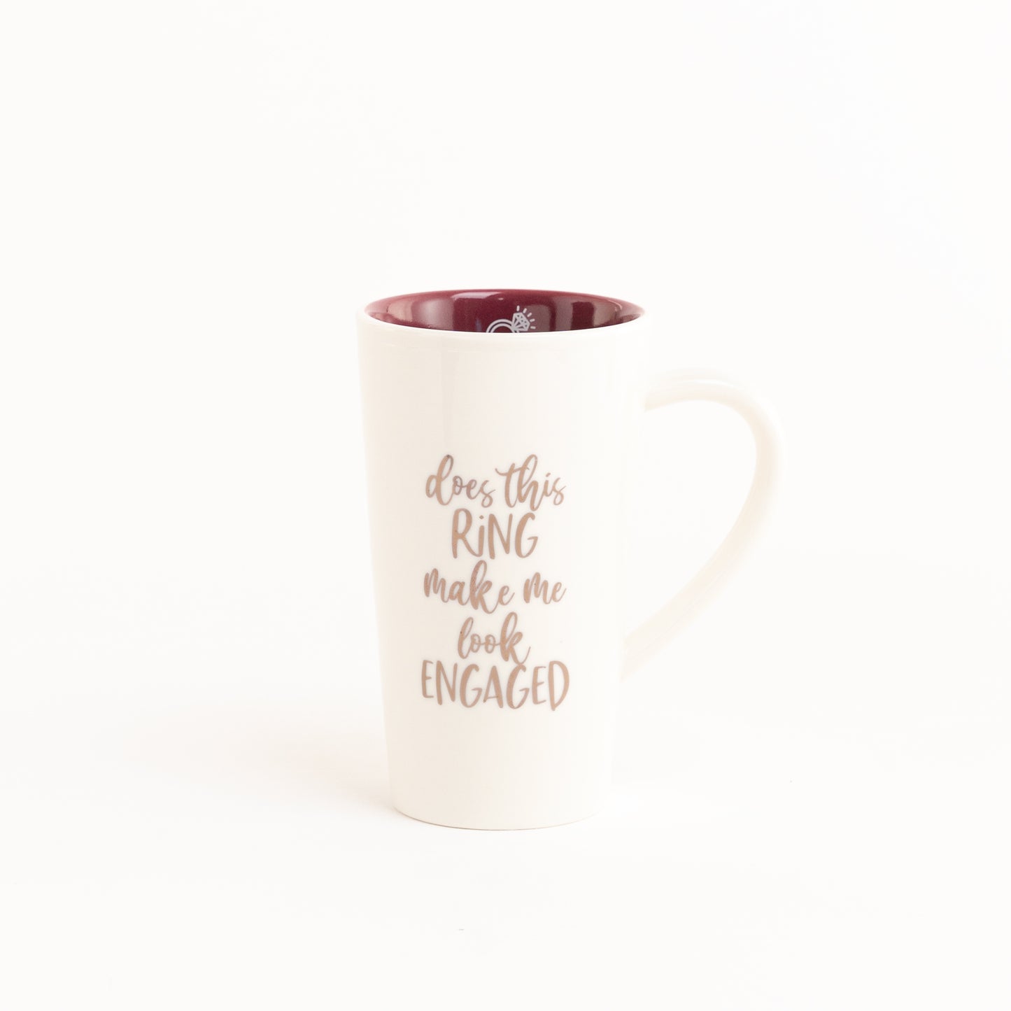 Cute ceramic mug that reads "Does This Ring Make Me Look Engaged?".