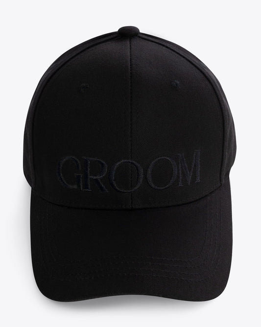 Black-on-black embroidered GROOM baseball hat comes with an adjustable brass buckle. Made of 100% cotton twill.