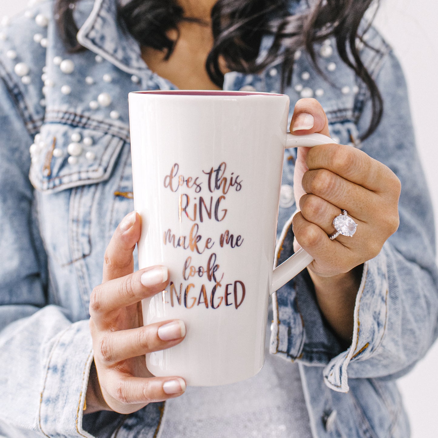 Cute ceramic mug that reads "Does This Ring Make Me Look Engaged?".