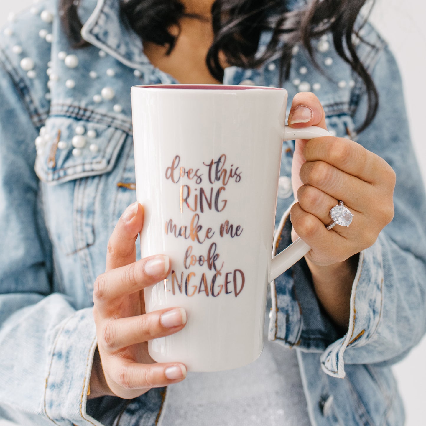 Cute ceramic mug that reads "Does This Ring Make Me Look Engaged?".