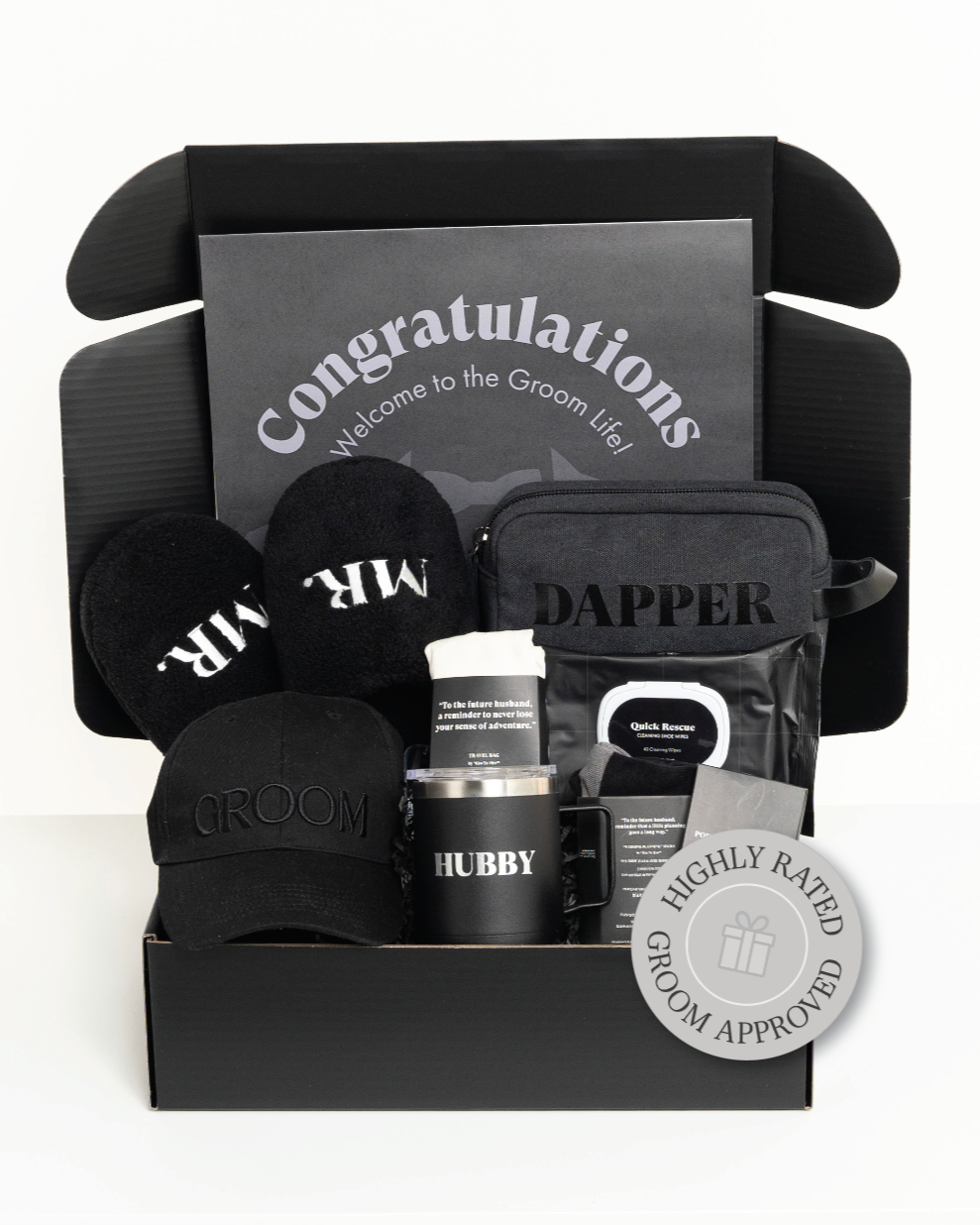 Groom gift set with hat, mug, slippers and other items in a black box labeled 'Congratulations Welcome to the Groom Life'.
