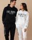 Couple wearing matching 'Hubby' and 'Wifey' hoodies and joggers with personalization. Wifey and Hubby hoodie and joggers sets with 3D puff print