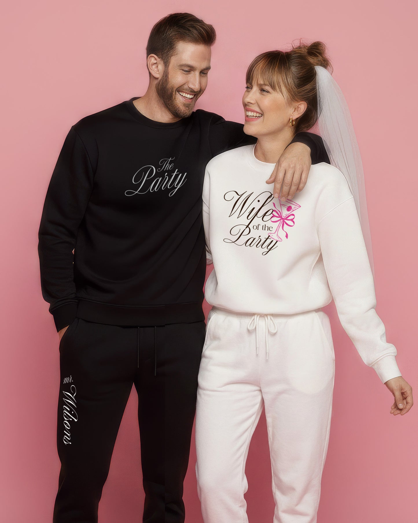 Couple wearing matching sweatshirts. 'Wife of the Party' sweatshirt for her and 'The Party' sweatshirt for him