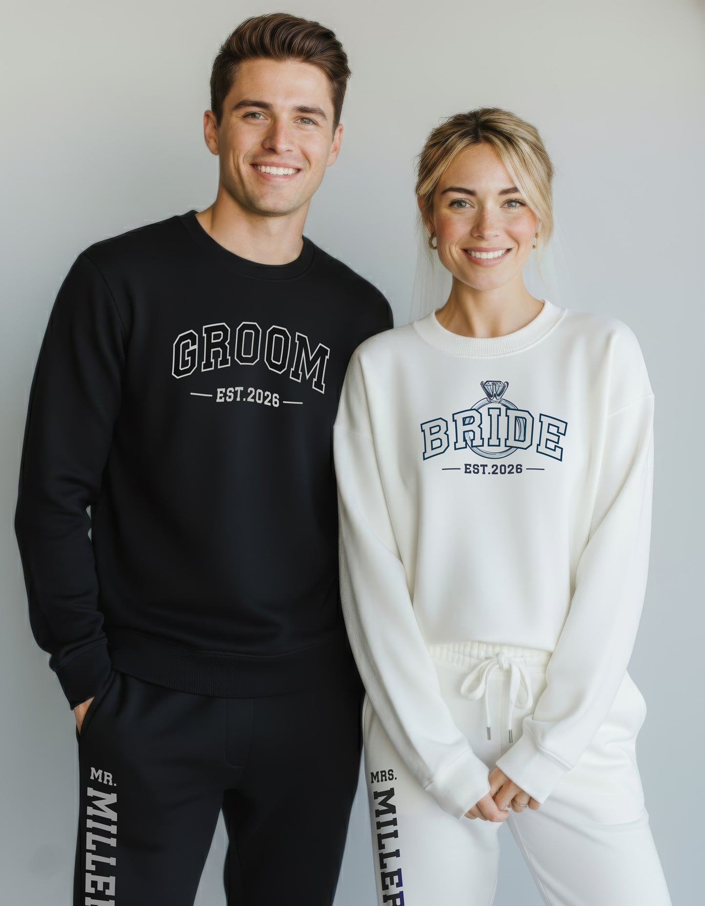 Couple wearing 'Groom' and 'Bride' sweatshirts and joggers. Matching Bride and Groom sets