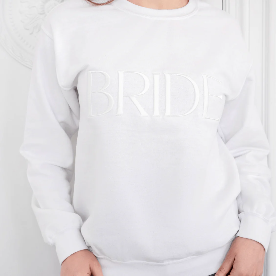 Made from a soft and comfortable 100% cotton blend, this sweatshirt features a beautiful "BRIDE" embroidery design.