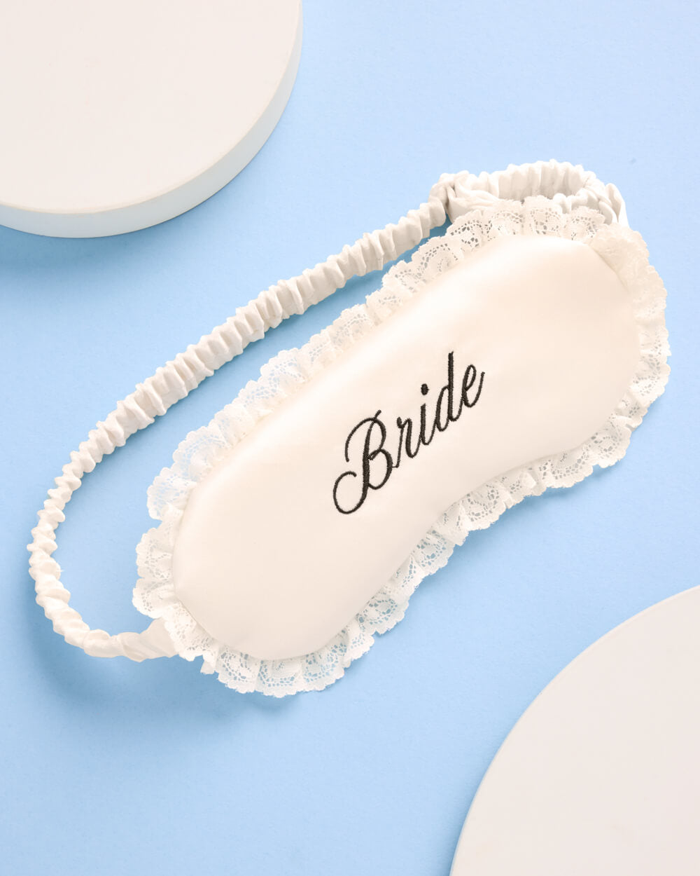 Sleep mask with 'Bride' text on a light blue background