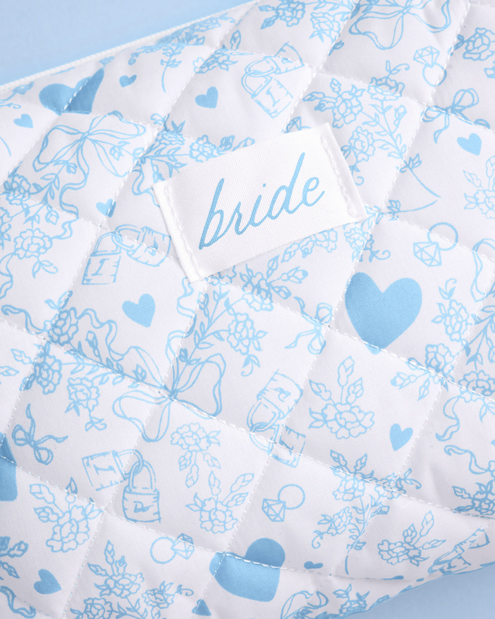 Floral and heart patterned fabric with 'bride' label on a light blue background