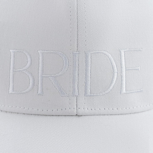 White-on-white embroidered BRIDE baseball hat comes with an adjustable brass buckle. Made of 100% cotton twill.