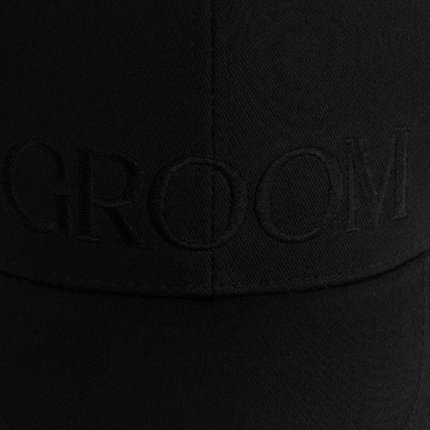 Black-on-black embroidered GROOM baseball hat comes with an adjustable brass buckle. Made of 100% cotton twill.